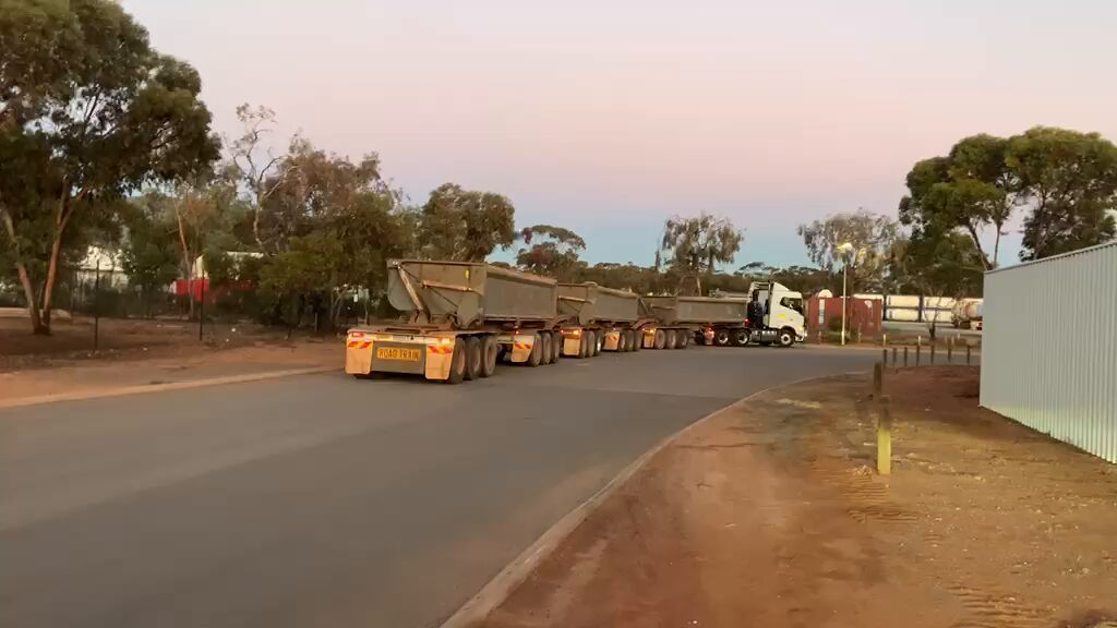 Road train departing at dusk in the Goldfields