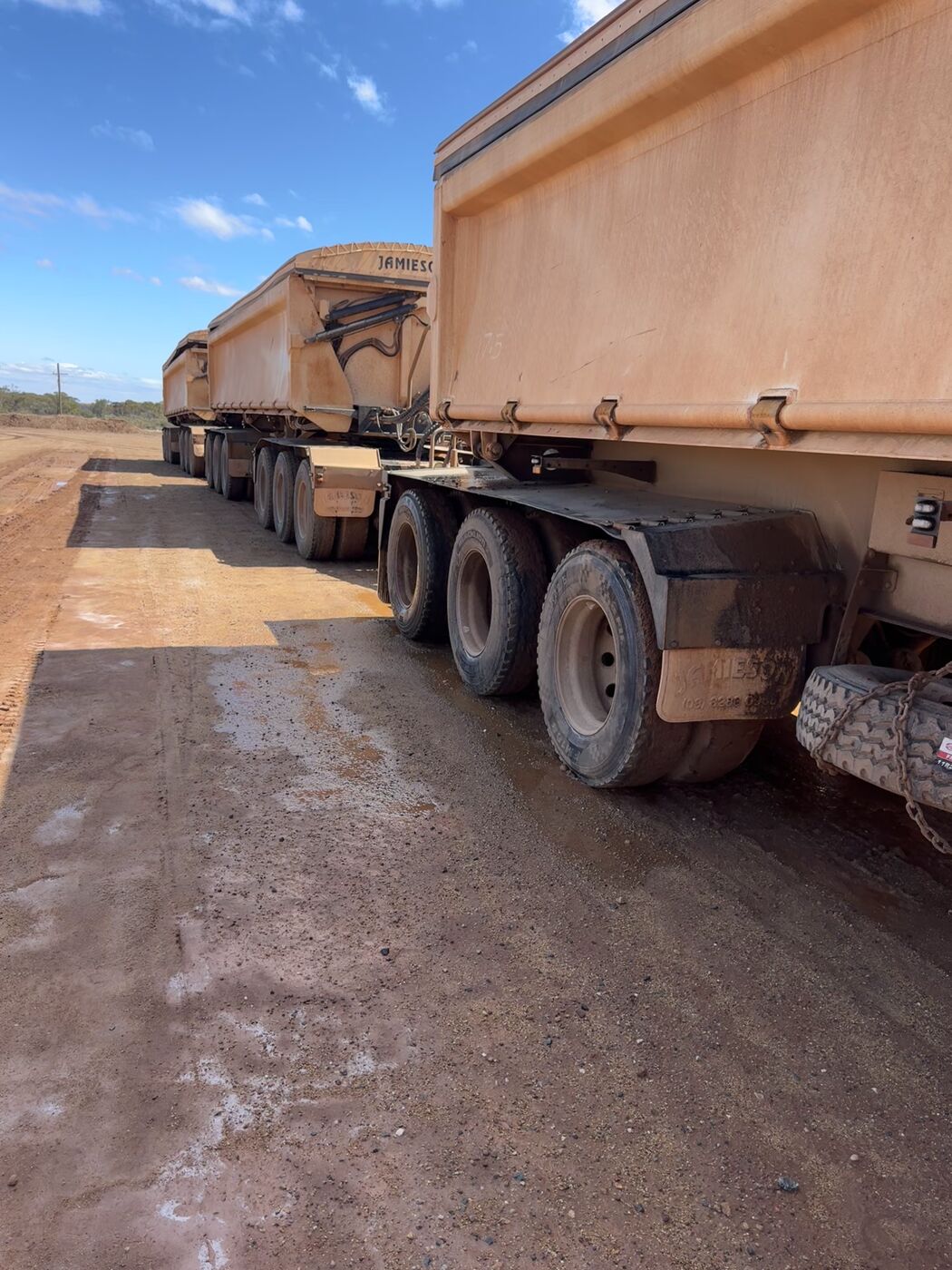 Close view of side-tipper trailer and dolly